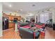 Open concept living room and kitchen area with red furniture and wood-look floors at 3329 Glacial Lake St, Las Vegas, NV 89122