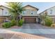 Inviting two-story home with a paved driveway and attached two-car garage at 361 Andy Wheeler Dr, Henderson, NV 89011