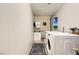 Simple laundry room with a washer, dryer, and small sink at 7075 Pinebrook Ct, Las Vegas, NV 89147