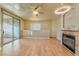 Living room with hardwood floors, fireplace, and balcony access at 7151 S Durango Dr # 214, Las Vegas, NV 89113