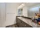 Clean bathroom with granite countertops and a double sink at 7881 Tyrell Peaks St, Las Vegas, NV 89139