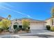 Single-story house with a two-car garage and well-maintained landscaping at 10105 Hill Country Ave, Las Vegas, NV 89134