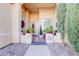 Covered front porch entryway with decorative plants and seating at 10201 Los Padres Pl, Las Vegas, NV 89134