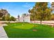 Putting green and expansive grassy backyard with mature trees at 1420 Westwood Dr, Las Vegas, NV 89102