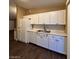 Kitchen with white appliances and cabinets with tile backsplash at 1608 Joshua Tree Ct, Las Vegas, NV 89108