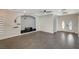 Living room with gray tile floors, built-in entertainment center, and double door entry at 1684 Spotted Wolf Ave, Las Vegas, NV 89123