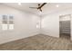 Spacious bedroom with neutral carpeting, ceiling fan, and walk-in closet at 1725 Bannie Ave, Las Vegas, NV 89102