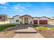 Beautiful home with red doors and a paved walkway at 1725 Bannie Ave, Las Vegas, NV 89102