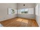 Living room with wood-look floors, large windows with shutters, and neutral walls at 1940 Las Palmas Ln # 269, Laughlin, NV 89029