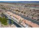 Aerial view of townhome community with tiled roofs, landscaping, and attached garages at 2160 Camel Mesa Dr, Laughlin, NV 89029