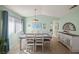 Dining room with wooden table, white chairs, and light green walls at 2160 Camel Mesa Dr, Laughlin, NV 89029