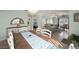 Open-concept dining area adjacent to the living room, featuring a wooden table and white chairs at 2160 Camel Mesa Dr, Laughlin, NV 89029