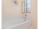 Bathroom featuring a bathtub, tiled walls, and a window at 2231 Camel Mesa Dr, Laughlin, NV 89029