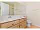 Bathroom vanity with large mirror and wood cabinets at 2231 Camel Mesa Dr, Laughlin, NV 89029