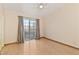 Bedroom with wood-look floors, ceiling fan, sliding glass door to balcony, and neutral walls at 2231 Camel Mesa Dr, Laughlin, NV 89029