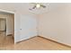 Spacious bedroom featuring wood-look floors, ceiling fan, and double sliding closet doors at 2231 Camel Mesa Dr, Laughlin, NV 89029