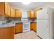 Bright kitchen with wood cabinets and white appliances at 3030 Mountain Vista St, Las Vegas, NV 89121