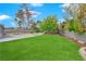 Landscaped backyard with grassy area and swimming pool at 3159 Vistoso Cir, Henderson, NV 89014