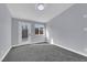 Well-lit bedroom with grey carpet and exterior access at 3159 Vistoso Cir, Henderson, NV 89014