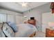 Bedroom with a wooden bed, ceiling fan, and white tile flooring at 3480 Cactus Shadow St # 101, Las Vegas, NV 89129