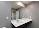 Bathroom vanity with a large mirror and white countertop at 6158 Kindlewood Cove Way, Las Vegas, NV 89148