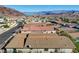 Elevated view of a residential property with a tiled roof, surrounded by similar homes and overlooking a lake at 623 Mount Elbert Way, Boulder City, NV 89005