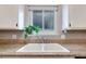 White double sink with granite countertop in a bright kitchen at 641 Pecos Way, Las Vegas, NV 89121