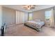 Spacious bedroom with large bed and window coverings at 6780 Pleasant Flower St, Las Vegas, NV 89149