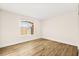 Bright bedroom with arched window and wood-look flooring at 7560 Glowing Ember Ct # 201, Las Vegas, NV 89130