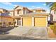 Two-story home with a two-car garage and landscaped yard at 7560 Glowing Ember Ct # 201, Las Vegas, NV 89130