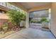 Covered patio, lush plants, and a serene atmosphere create a private outdoor oasis at 8904 Martin Downs Pl, Las Vegas, NV 89131