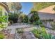 Spacious backyard with lush greenery, pathways, and desert landscaping at 8904 Martin Downs Pl, Las Vegas, NV 89131