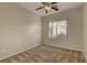 Bright bedroom with a ceiling fan, large window, and patterned carpet at 8904 Martin Downs Pl, Las Vegas, NV 89131