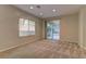 Living area with sliding glass door to backyard, carpet, and recessed lighting at 8904 Martin Downs Pl, Las Vegas, NV 89131