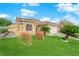 Tan house with a two-car garage and nicely landscaped yard at 9108 Chenin Ave, Las Vegas, NV 89129