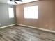 Spacious bedroom with wood-look floors and large window at 9144 Starling Wing Pl, Las Vegas, NV 89143