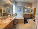 Spacious bathroom with double sinks, a soaking tub, and a large window at 9391 Olympia Falls Ave, Las Vegas, NV 89149