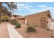 Tan stucco house with walkway, landscaping, and attached garage at 4241 Park Ct, Las Vegas, NV 89110