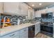 Modern kitchen with white cabinets, stainless steel appliances, and quartz countertops at 4339 Pittsfield St, Las Vegas, NV 89115