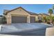 Two-story house with a three-car garage and desert landscaping at 5001 Wild Thyme Ave, Las Vegas, NV 89131