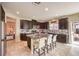 Modern kitchen with dark cabinetry, granite countertops, and an island at 5504 Emerald Basin St, North Las Vegas, NV 89031