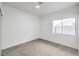 Simple bedroom with carpet, large window and ceiling fixture at 5604 Island Breeze Ct, Las Vegas, NV 89130