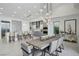 Modern dining room with large wooden table and statement lighting at 667 Palisade Rim Dr, Henderson, NV 89012