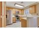 Galley kitchen, stainless steel appliances, wood cabinets at 6875 Tamarus St # 103, Las Vegas, NV 89119