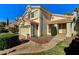 Two-story house with tan exterior, tile roof, and a two-car garage at 8300 Bermuda Beach Dr, Las Vegas, NV 89128