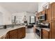 Modern kitchen with stainless steel appliances and wooden cabinets at 1081 Pleasure Ln # 1, Henderson, NV 89002