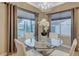 Elegant dining area with glass table and white chairs near kitchen at 2094 Sawtooth Mountain Dr, Henderson, NV 89044