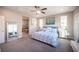 Main bedroom with blue and white bedding and ensuite bathroom at 23 Cresta Villa Ct, Henderson, NV 89011