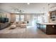 Bright living room featuring an L-shaped sofa and kitchen views at 23 Cresta Villa Ct, Henderson, NV 89011