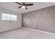 Bedroom with geometric accent wall and ceiling fan at 453 Kings Ave, North Las Vegas, NV 89030